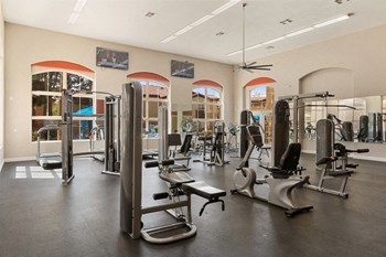 Fitness center with weight machines and large windows